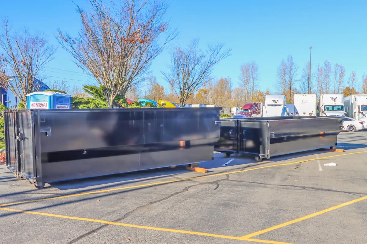 Professional dumpster rental service with roll-off container on residential driveway in Prescott